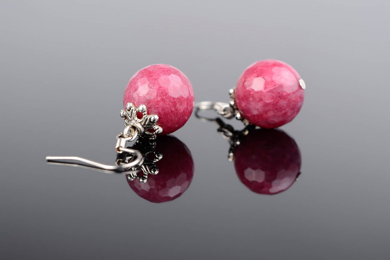 Ball earrings with a young ruby photo 1