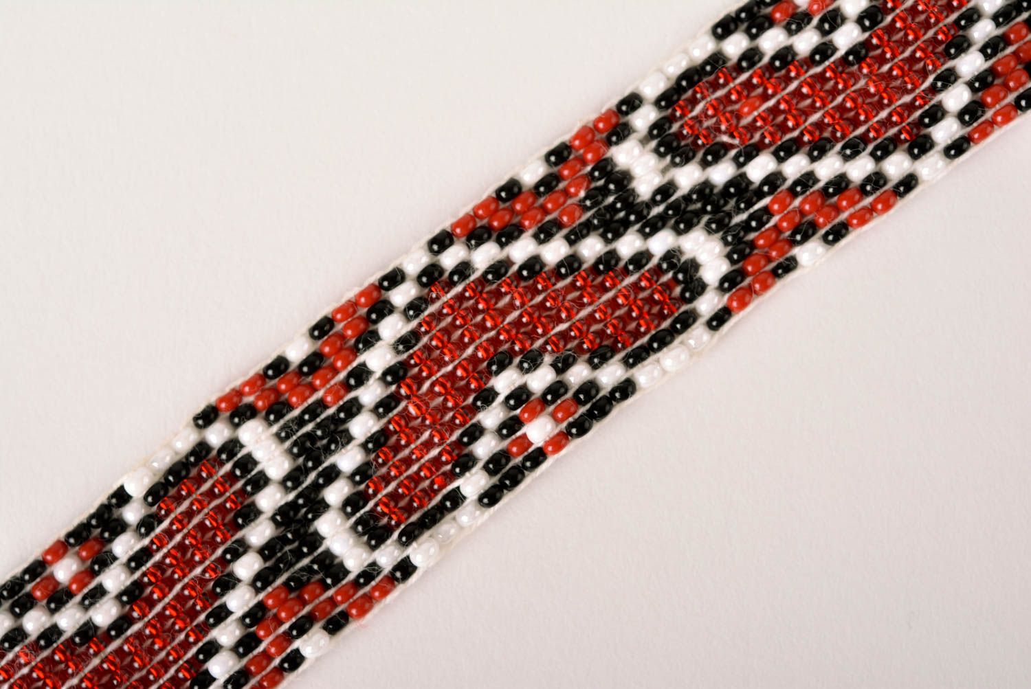 Handmade beaded bracelet with Ukrainian style ornament in red, black, and white color photo 3