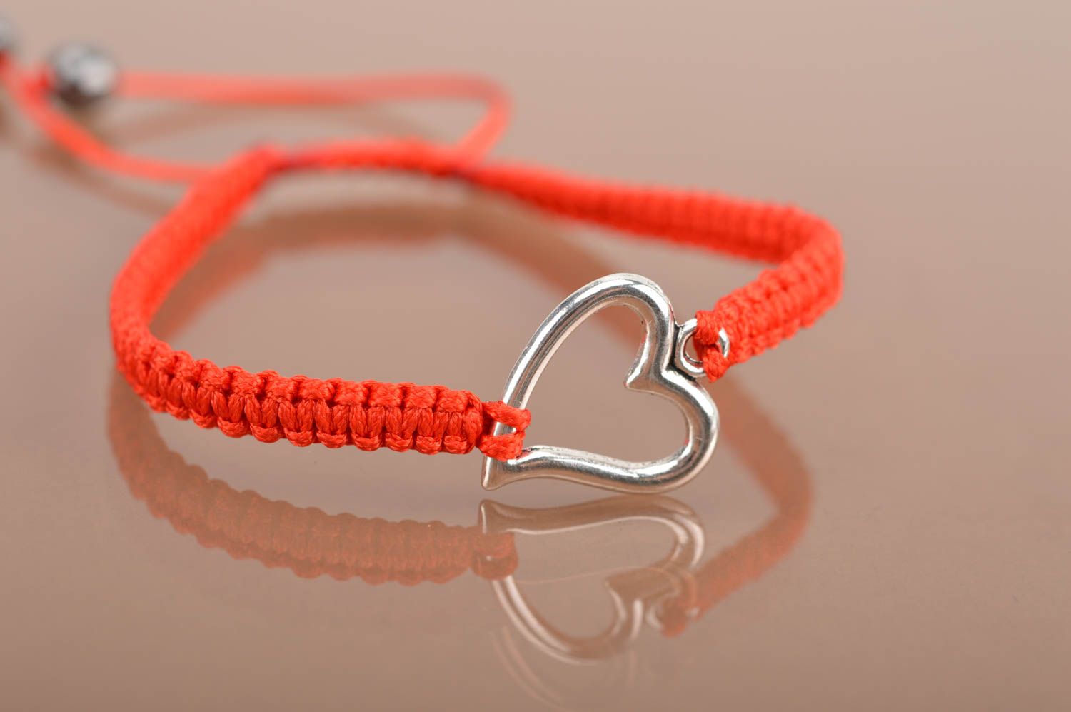 Handmade red bracelet made of silk threads with insert in shape of heart photo 2