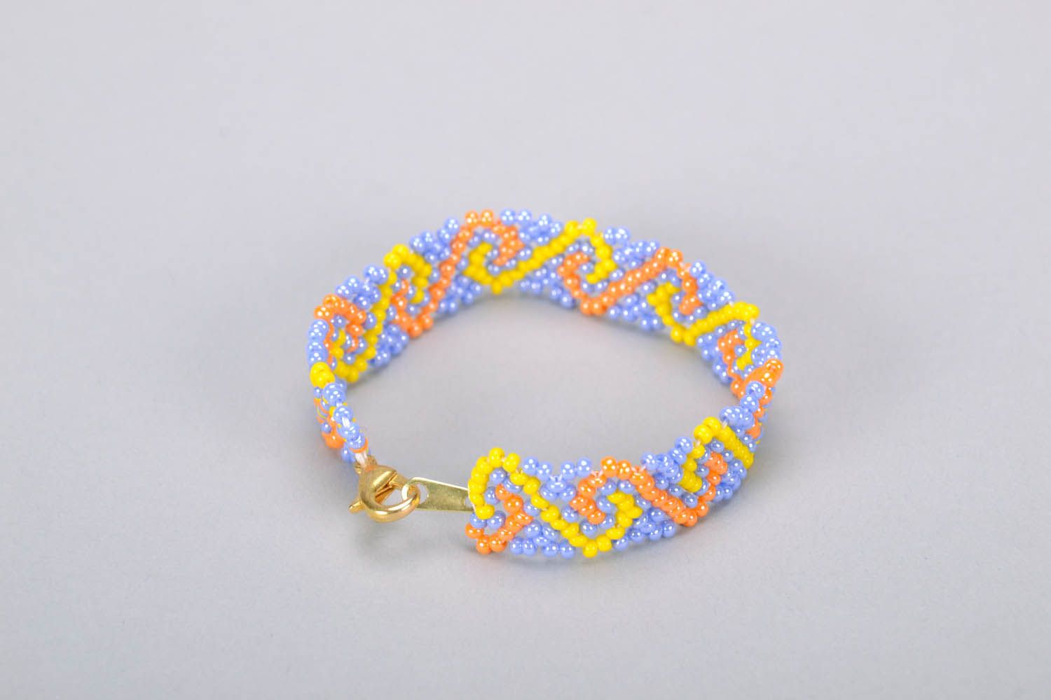 Beaded bracelet with orange, yellow, and blue beads photo 2