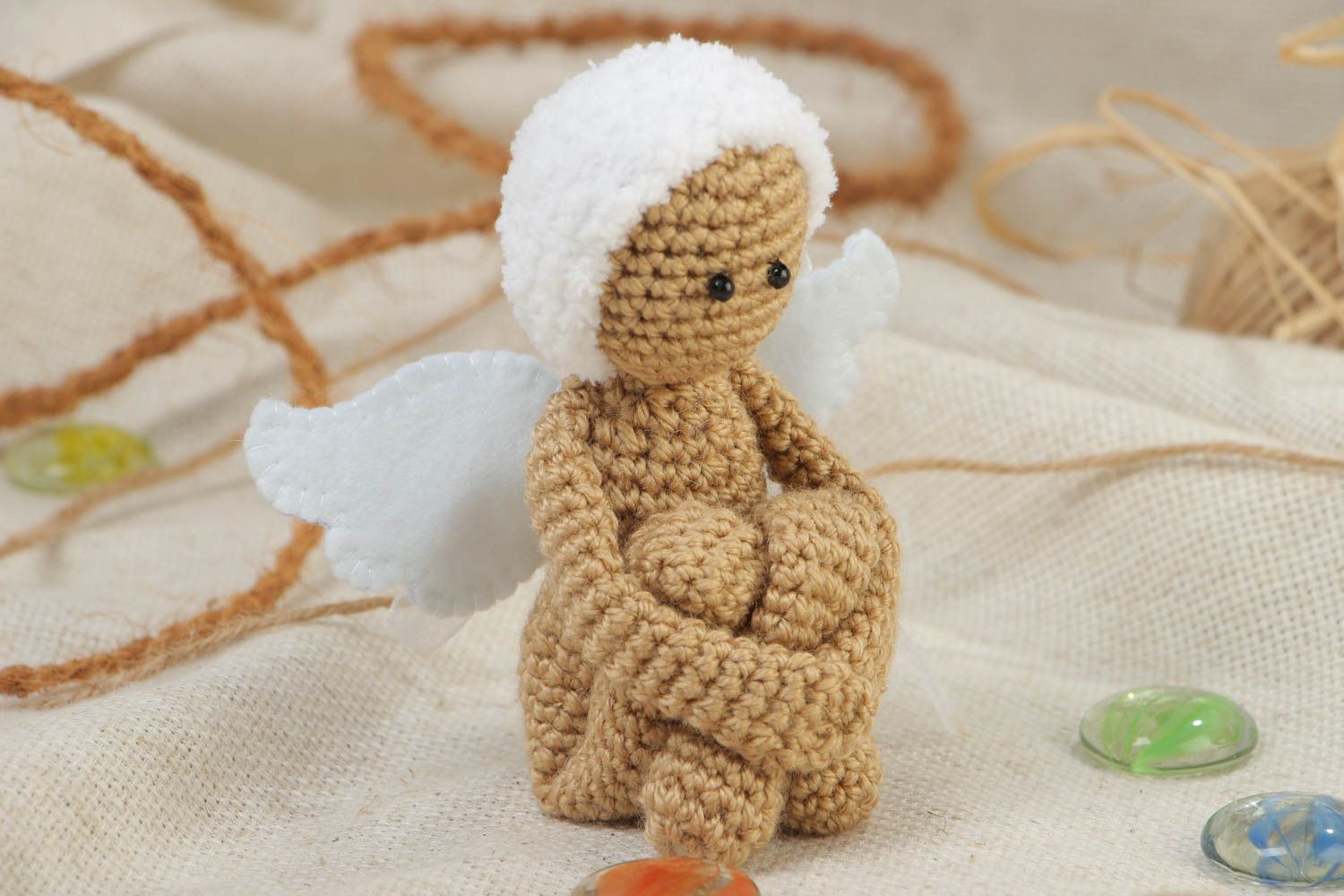 Small handmade knitted angel toy made of acrylic yarn using knitting needle photo 1