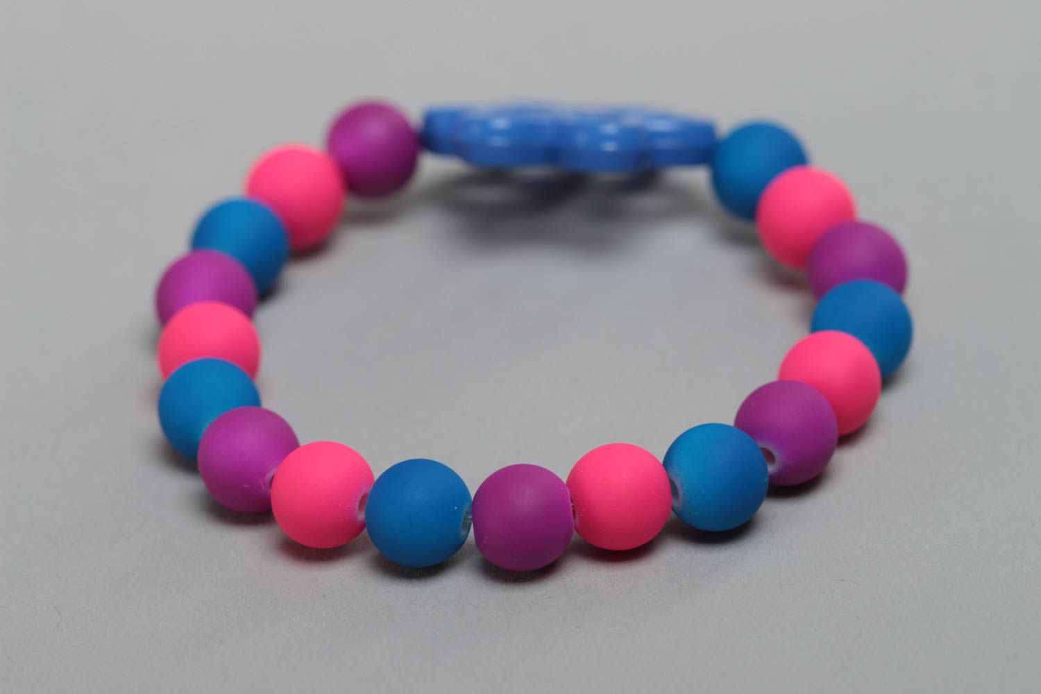 Colorful homemade children's wrist bracelet with plastic beads and flower photo 4