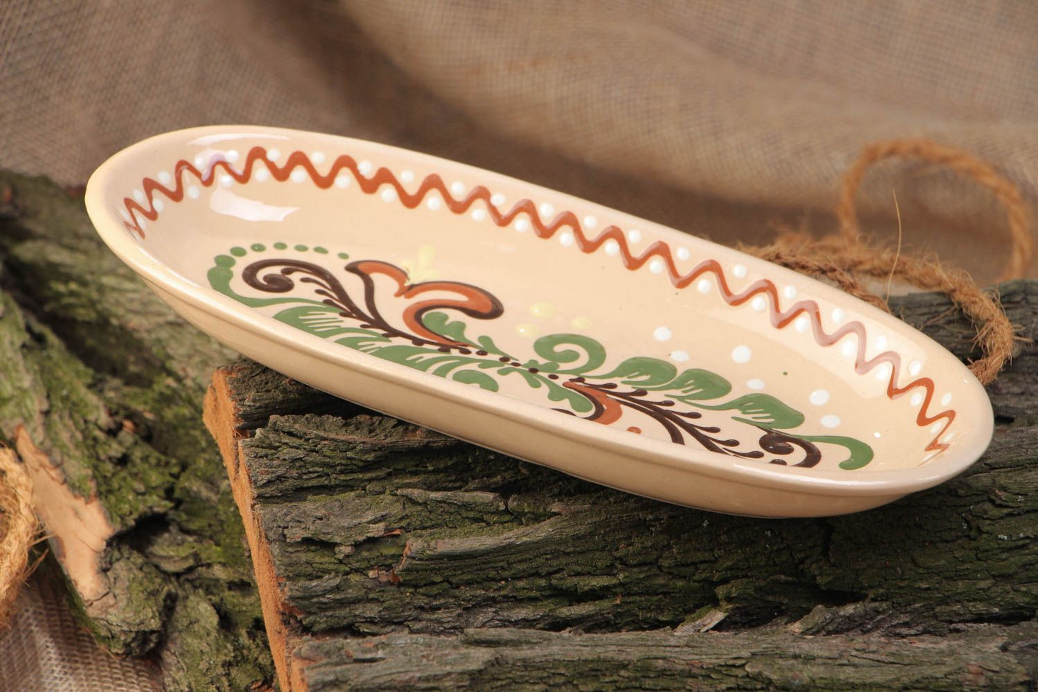 Homemade long ceramic dish ornamented with colorful glaze for serving fish photo 1