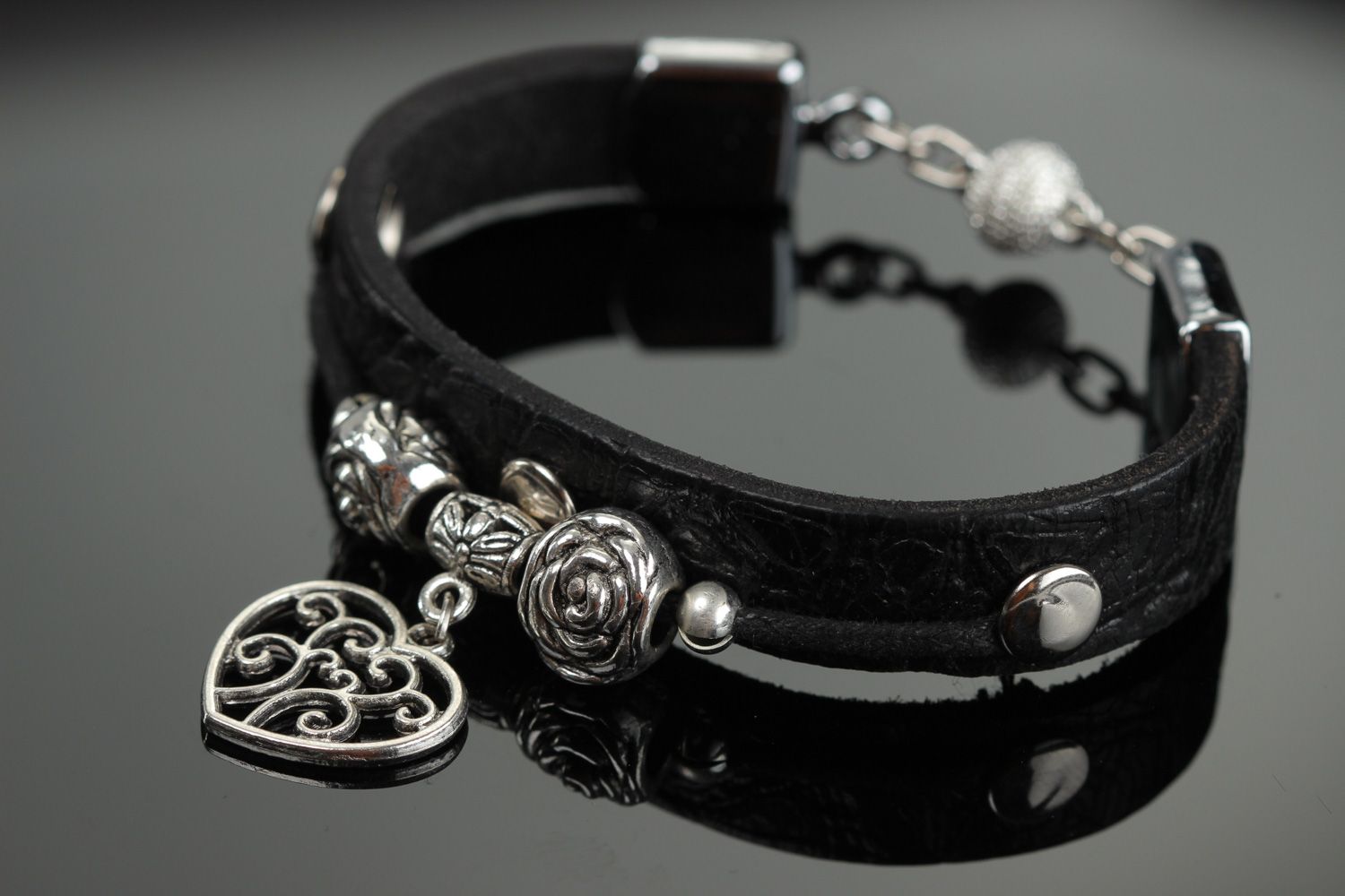 Handmade genuine leather women's wrist bracelet of black color with metal inserts  photo 1