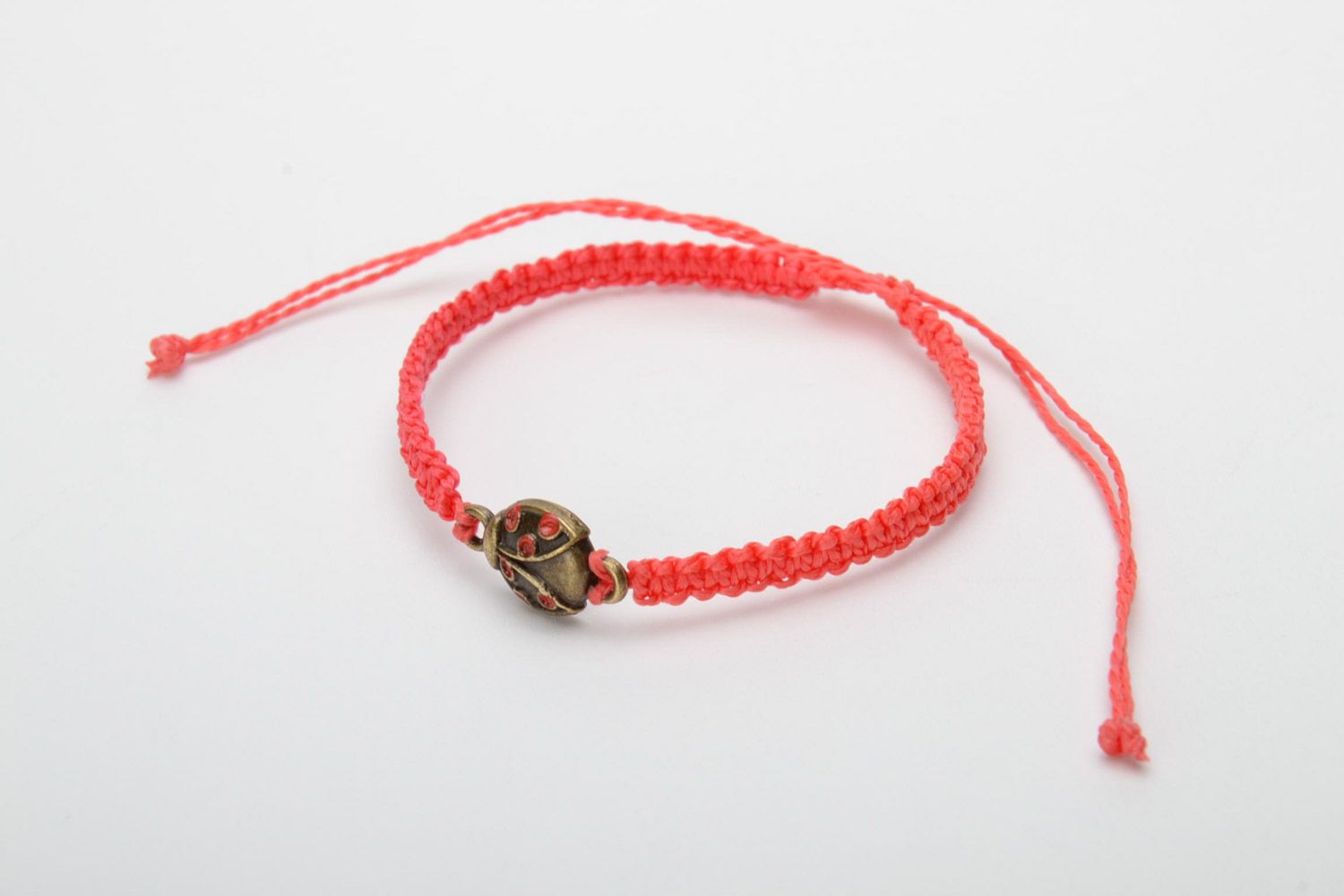 Handmade women's macrame woven cord bracelet of red color with charm photo 3