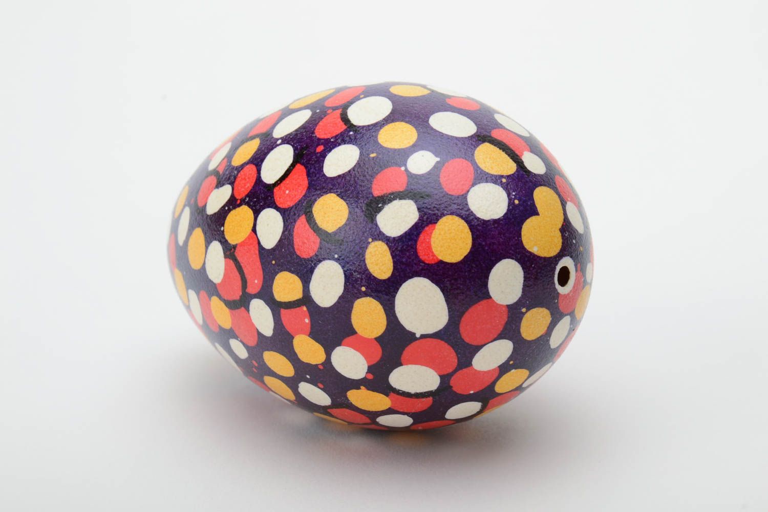 Handmade unusual Easter egg with colorful polka dot pattern on dark background photo 4