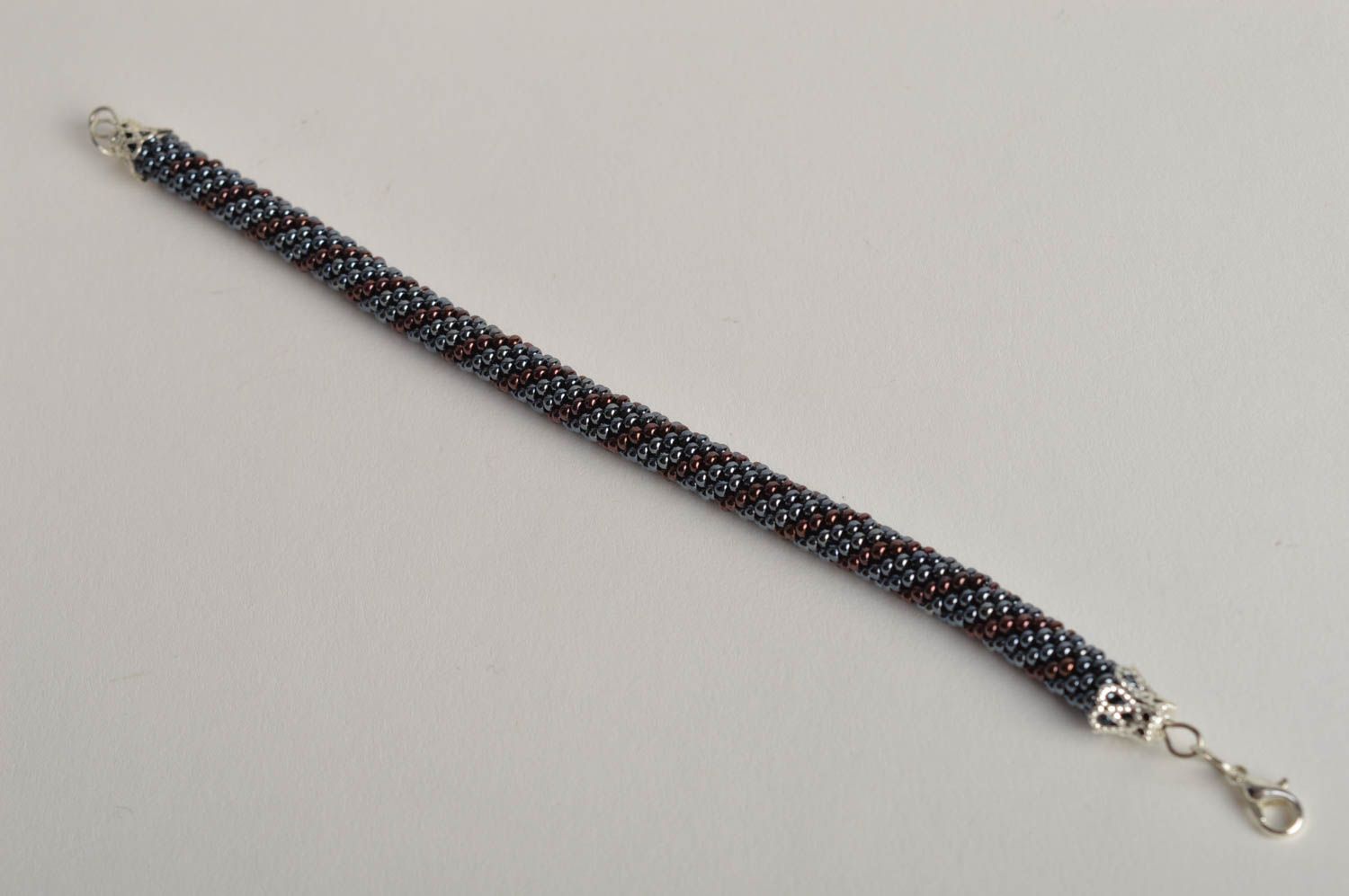 Handmade beaded cord bracelet in silver and dark cherry color photo 2