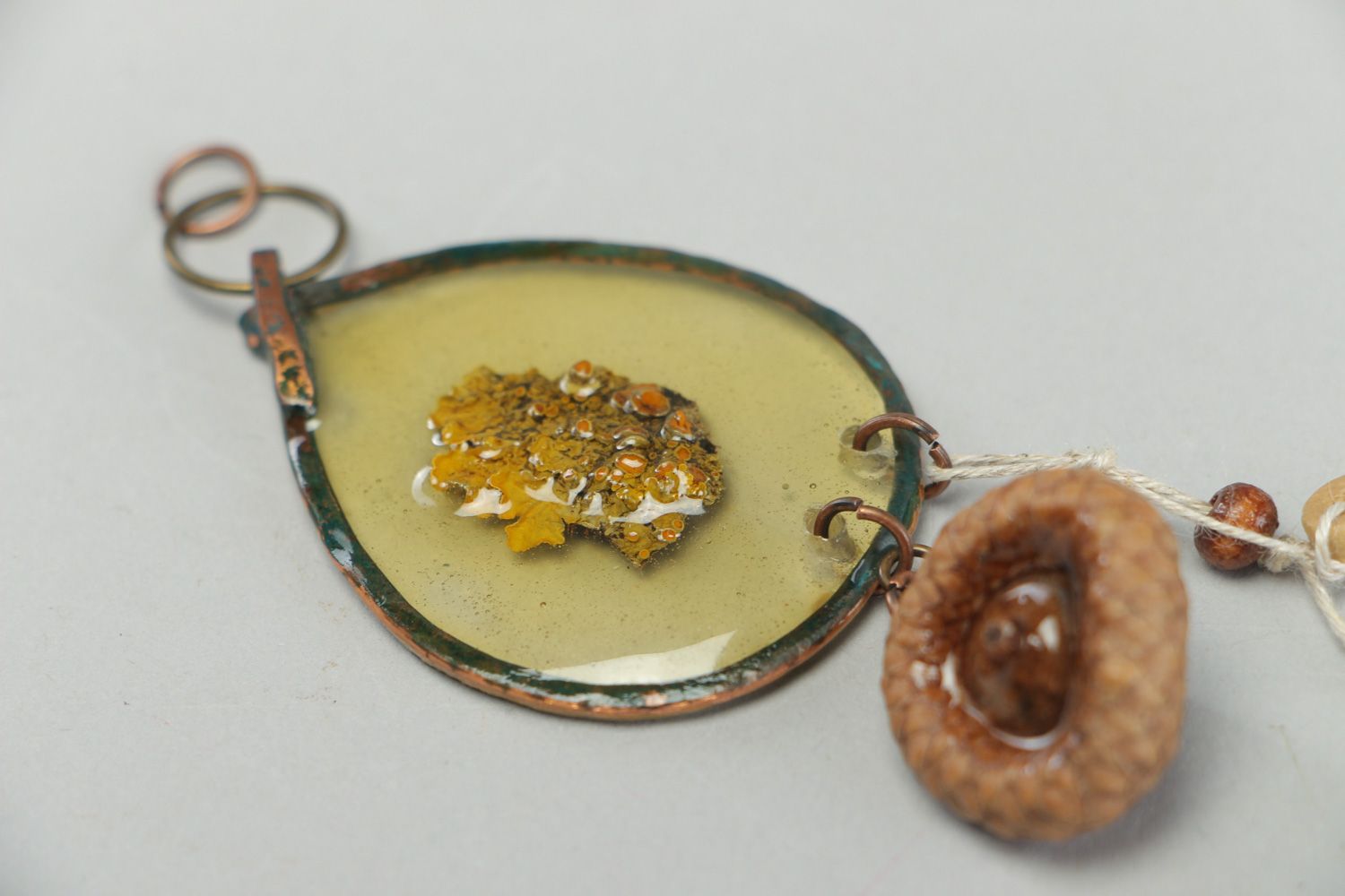 Handmade neck pendant with bark and acorn hat embedded in epoxy resin  photo 3