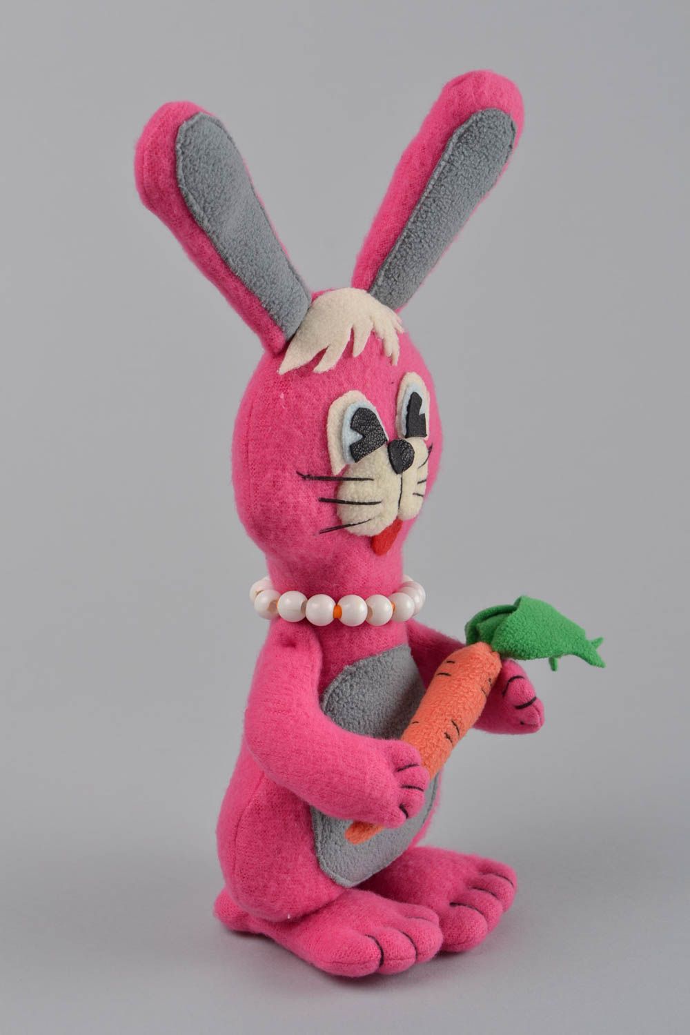 Handmade designer small soft toy sewn of fleece pink rabbit with carrot photo 3