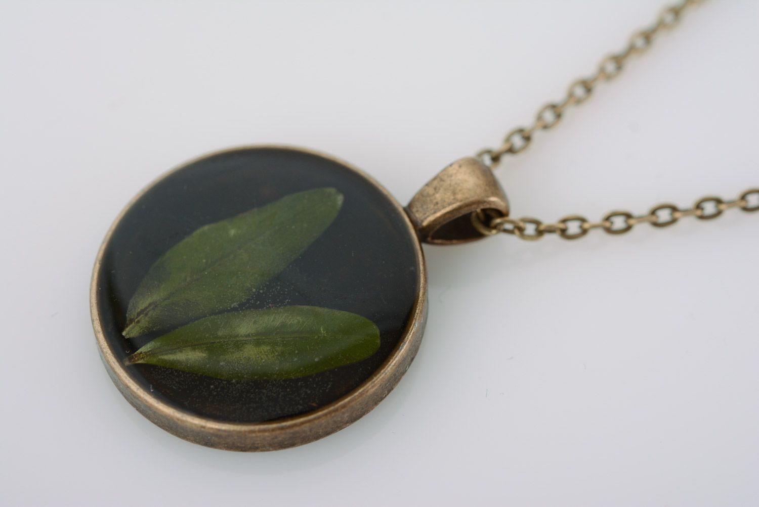 Handmade round black pendant with natural flower in epoxy resin on metal chain  photo 2