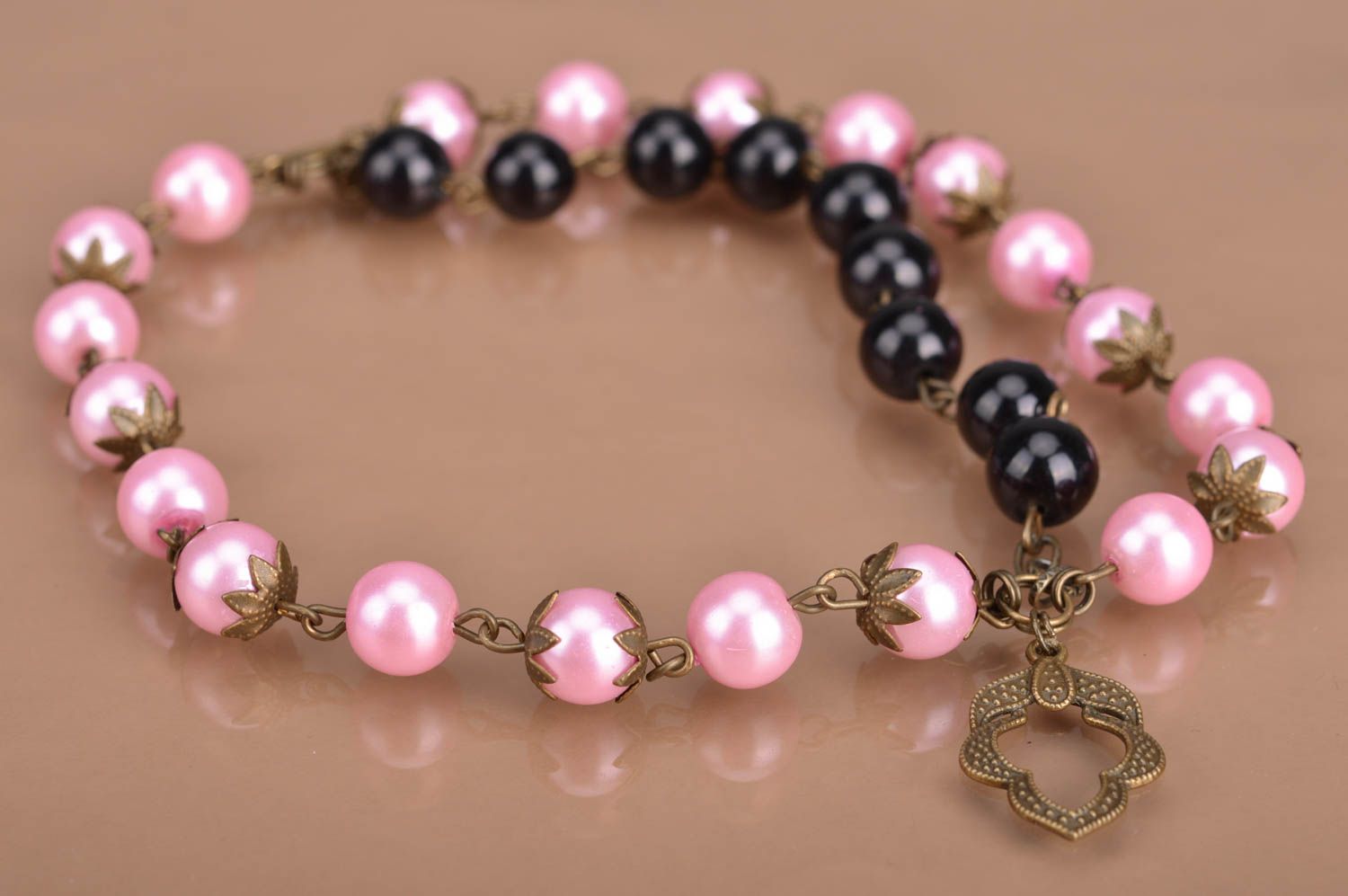 Handmade designer women's wrist bracelet with pink and black beads and charm photo 2