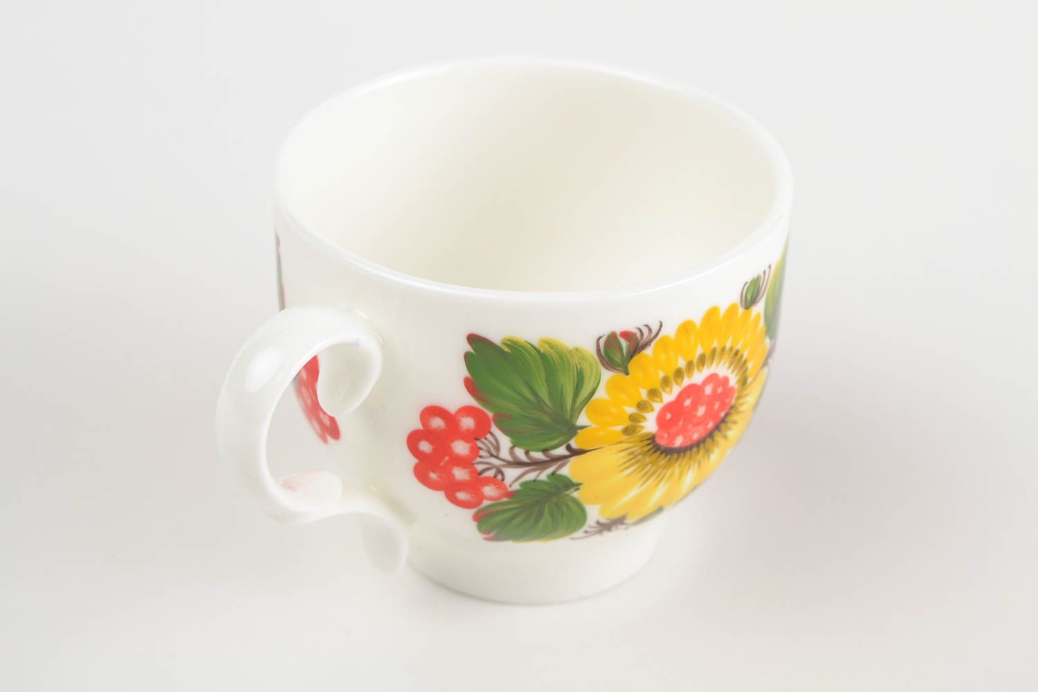White porcelain handmade teacup with bright Russian-style floral pattern in green, red, and yellow color photo 4