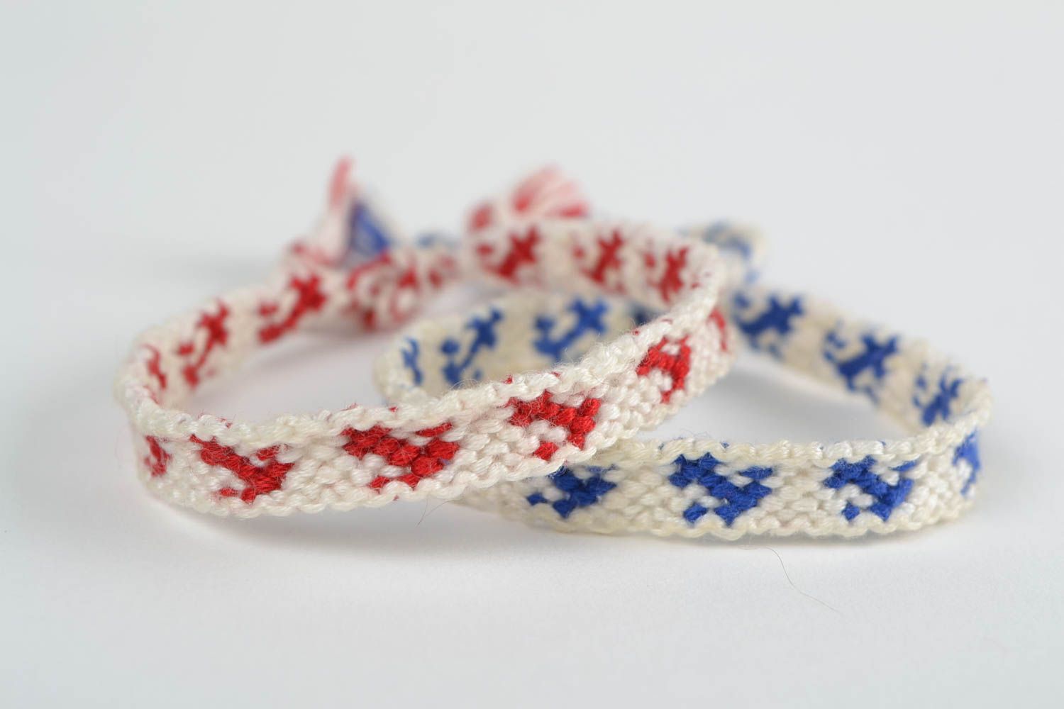 Set of 2 handmade white friendship wrist bracelets with red and blue inserts photo 4