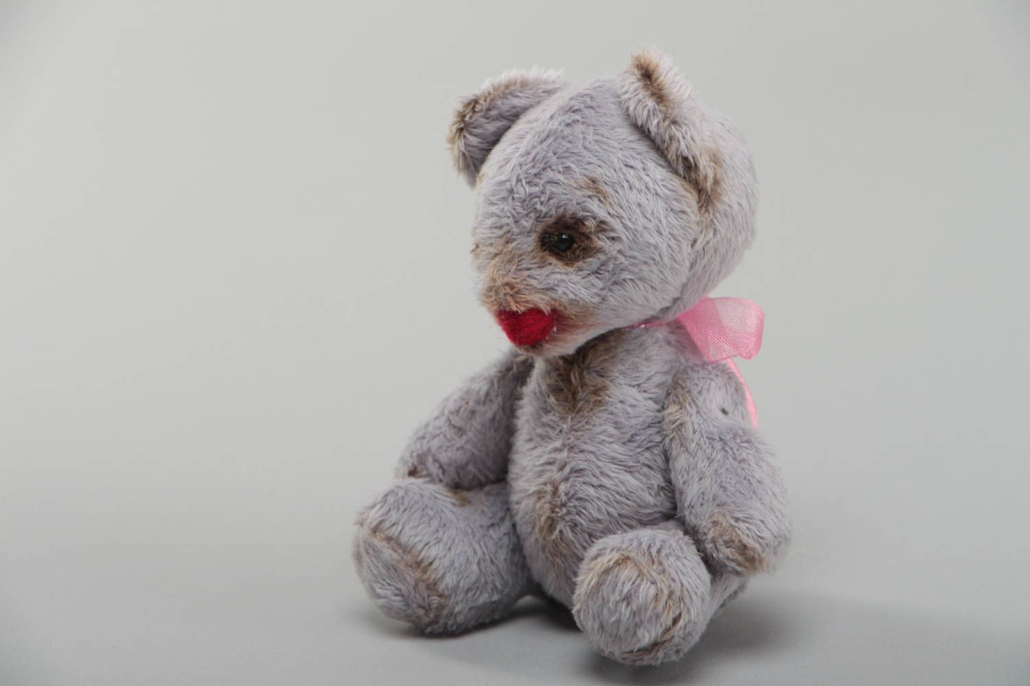 Handmade small faux fur soft toy bear of gray color with pink bow for children photo 2