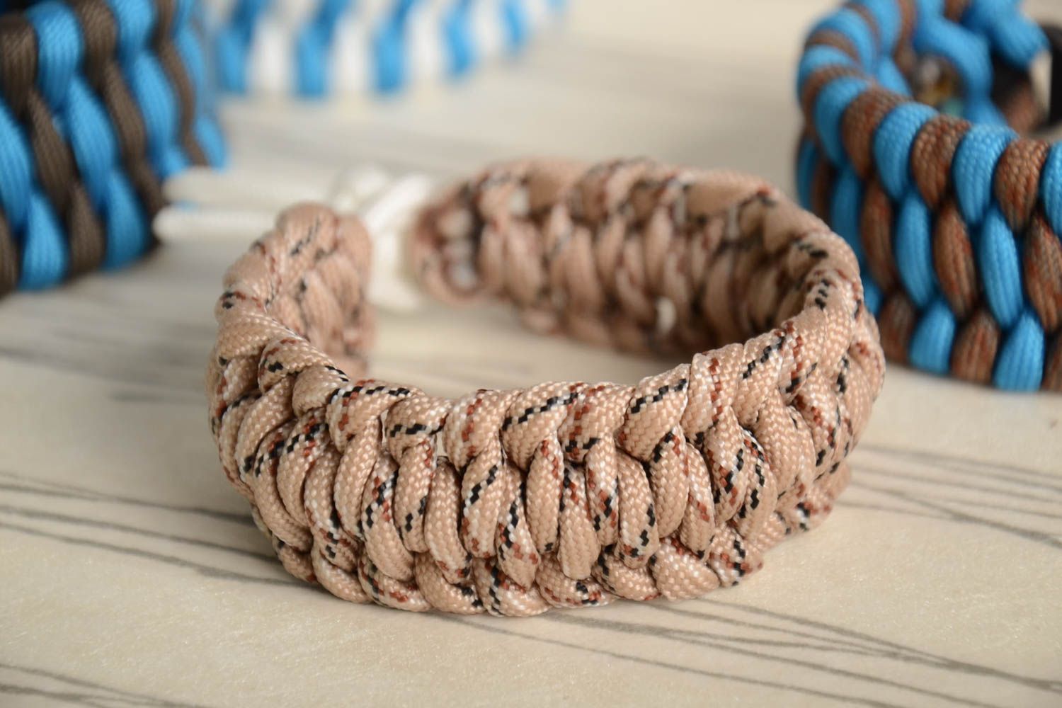 Handmade broad survival wrist bracelet woven of parachute cord of beige color  photo 1