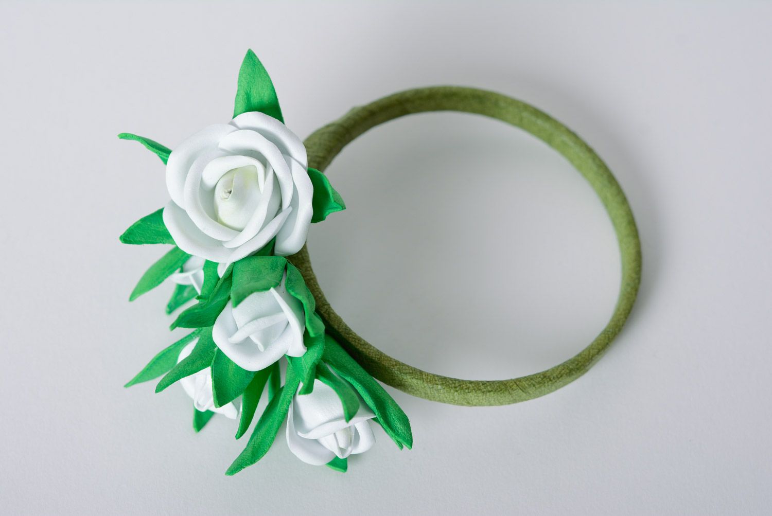 Handmade gentle foamiran fabric wrist bracelet with white flowers on green basis photo 1