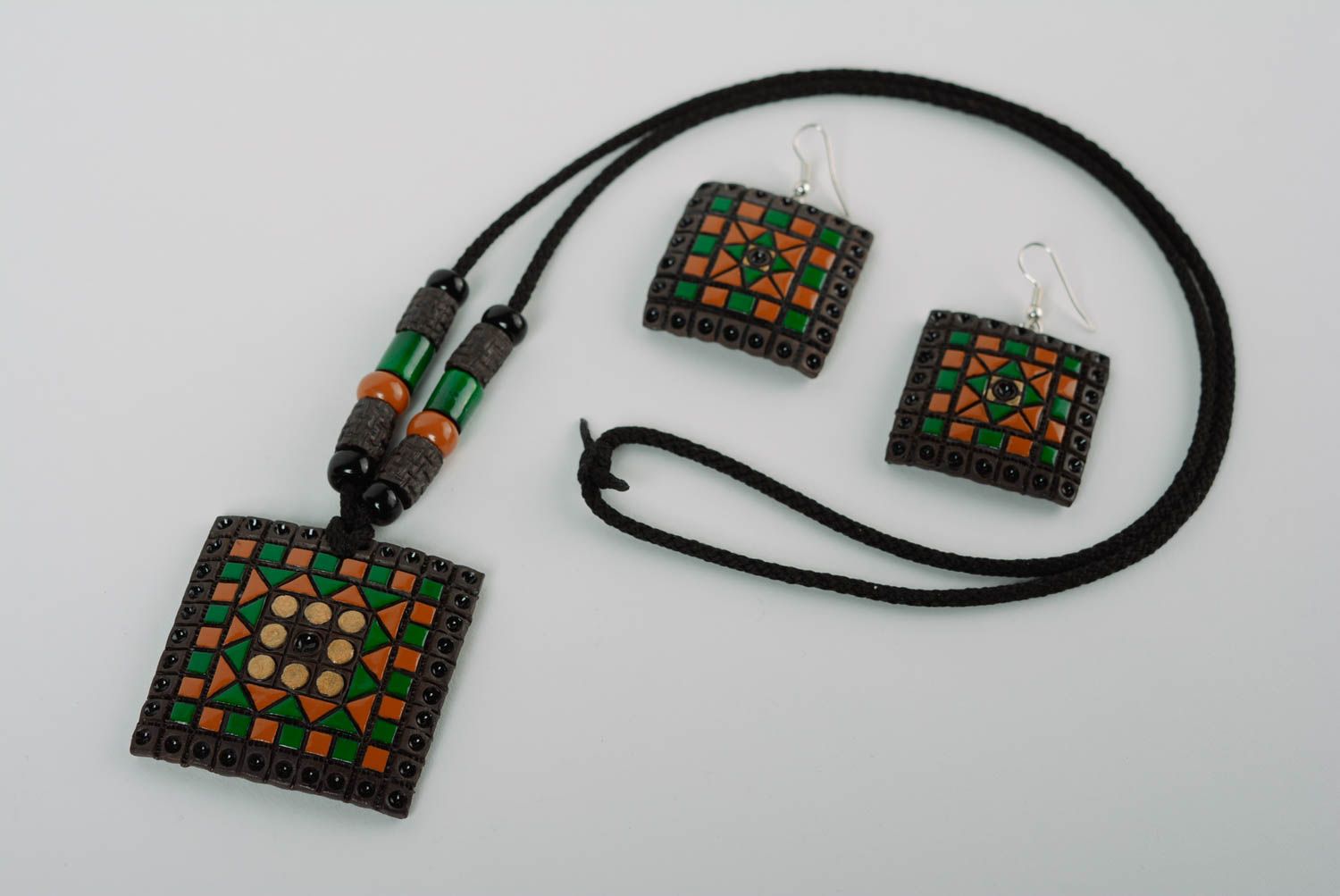 A set of handcrafted ceramic earrings and necklace made of clay with colored enamel paintings photo 1