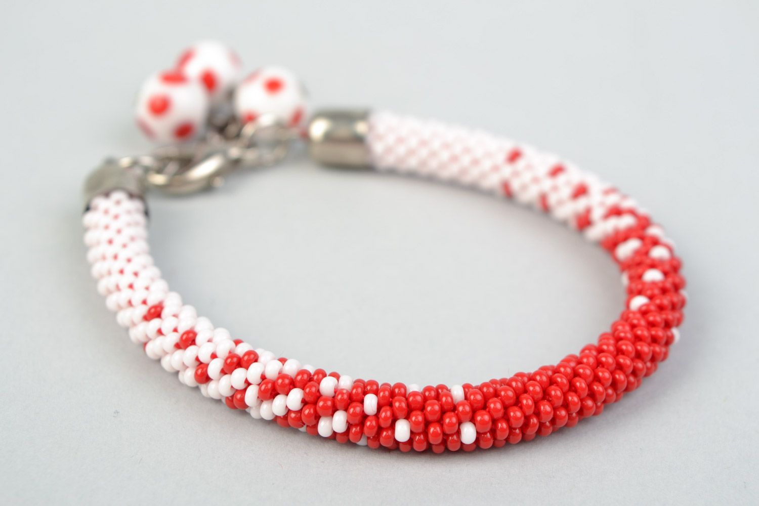 Handmade festive white and red beaded wrist bracelet with charms for women photo 3