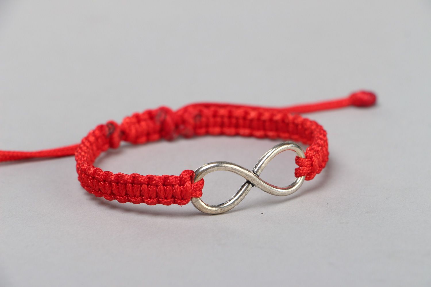 Handmade wrist friendship bracelet with synthetic cord of red color Eternity photo 1