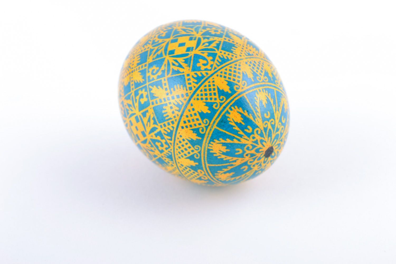 Bright painted handmade Easter egg with rich pattern of yellow and blue colors photo 4