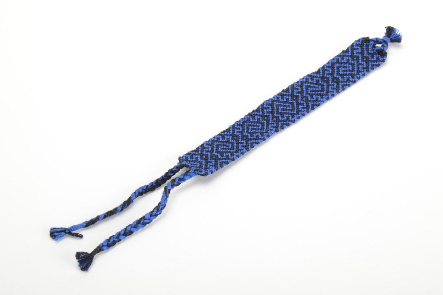 Handmade friendship bracelet woven of threads with blue and black ornament  photo 2
