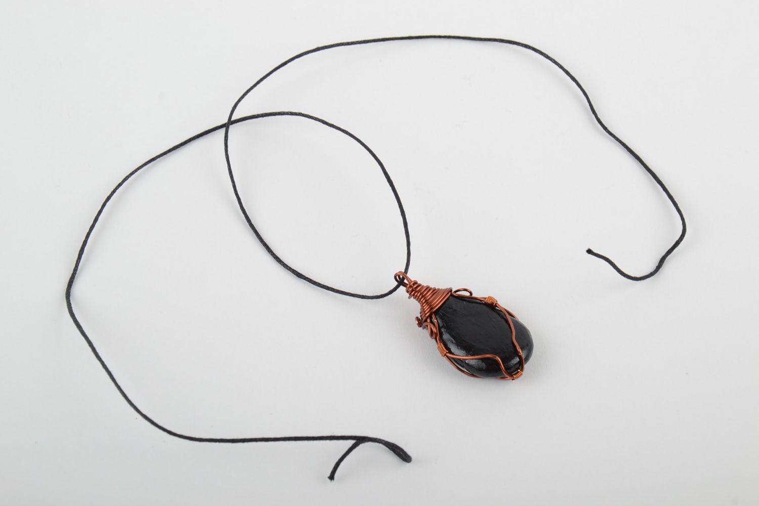 Unusual handmade plastic pendant woven over with copper wire and equipped with cord photo 3