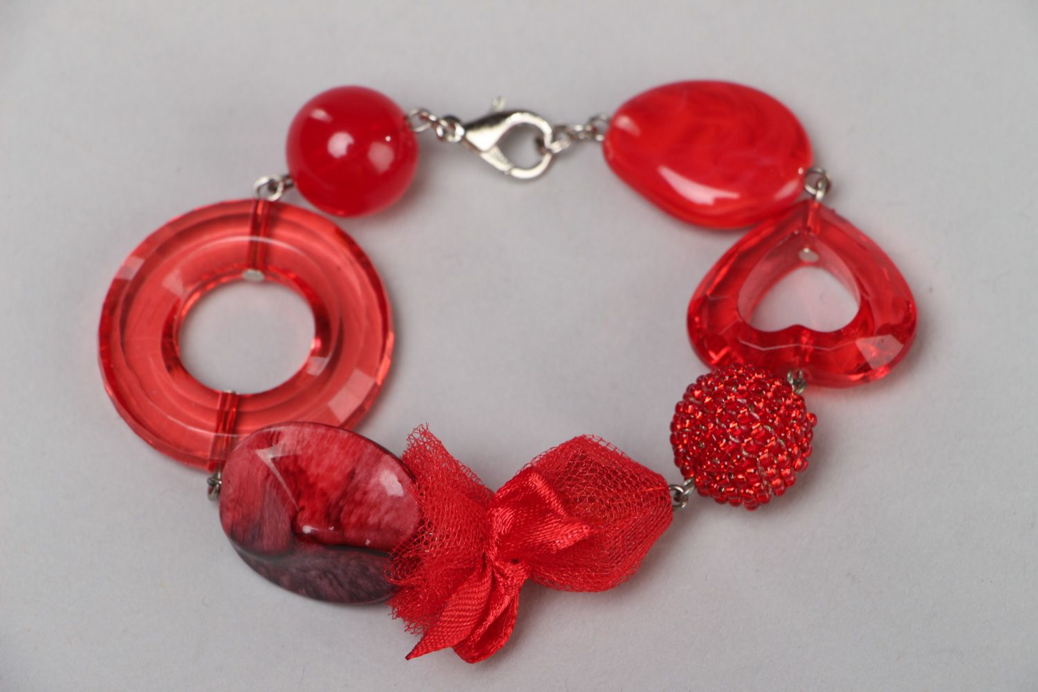 Handmade bright red wrist bracelet with plastic beads and metal fastener photo 1