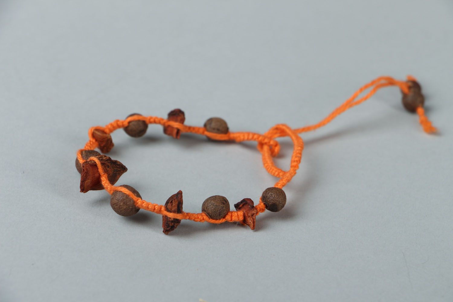 Homemade aroma strand bracelet on an orange rope with coffee beans photo 2