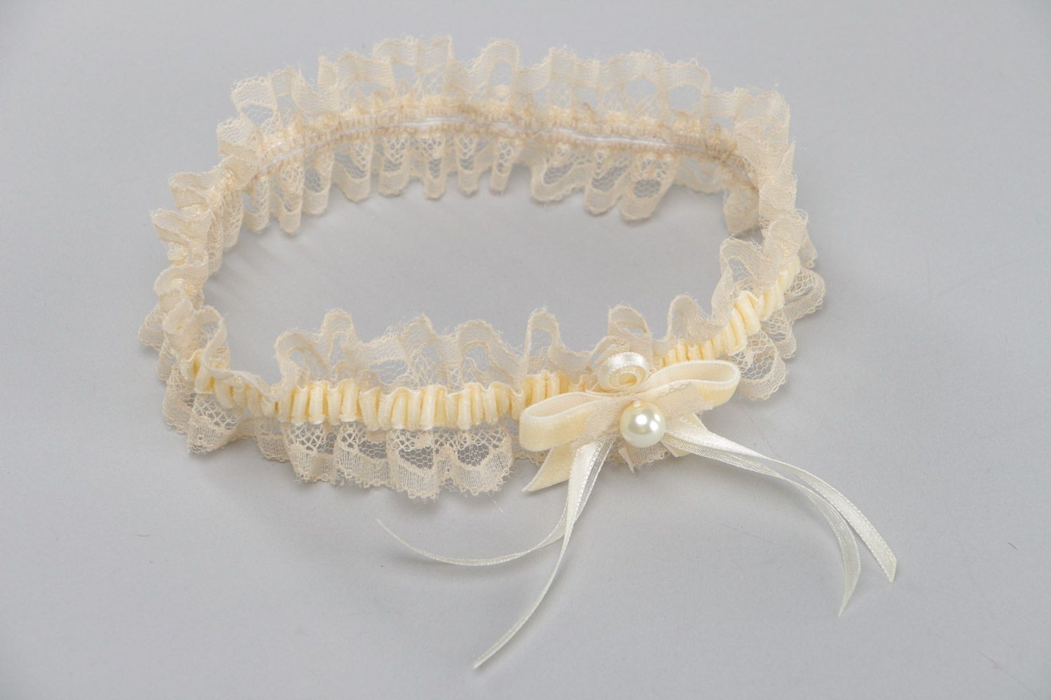 Tender thin lacy wedding bridal garter of champagne color with velor and pearls  photo 4