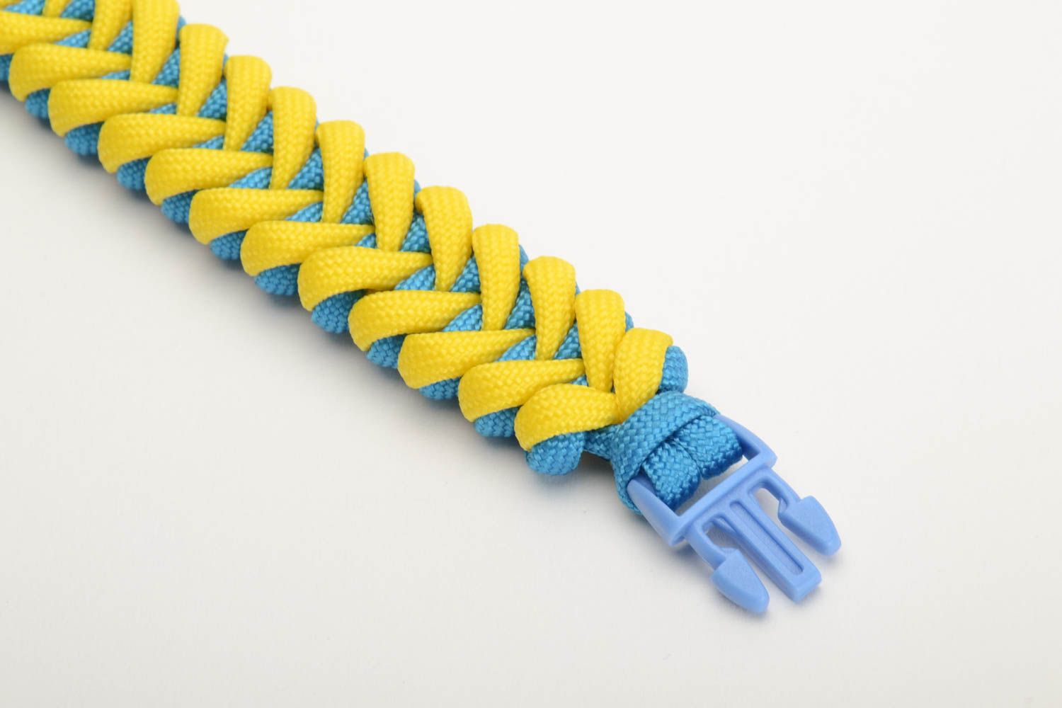 Handmade wrist survival bracelet woven of yellow and blue parachute cords photo 2