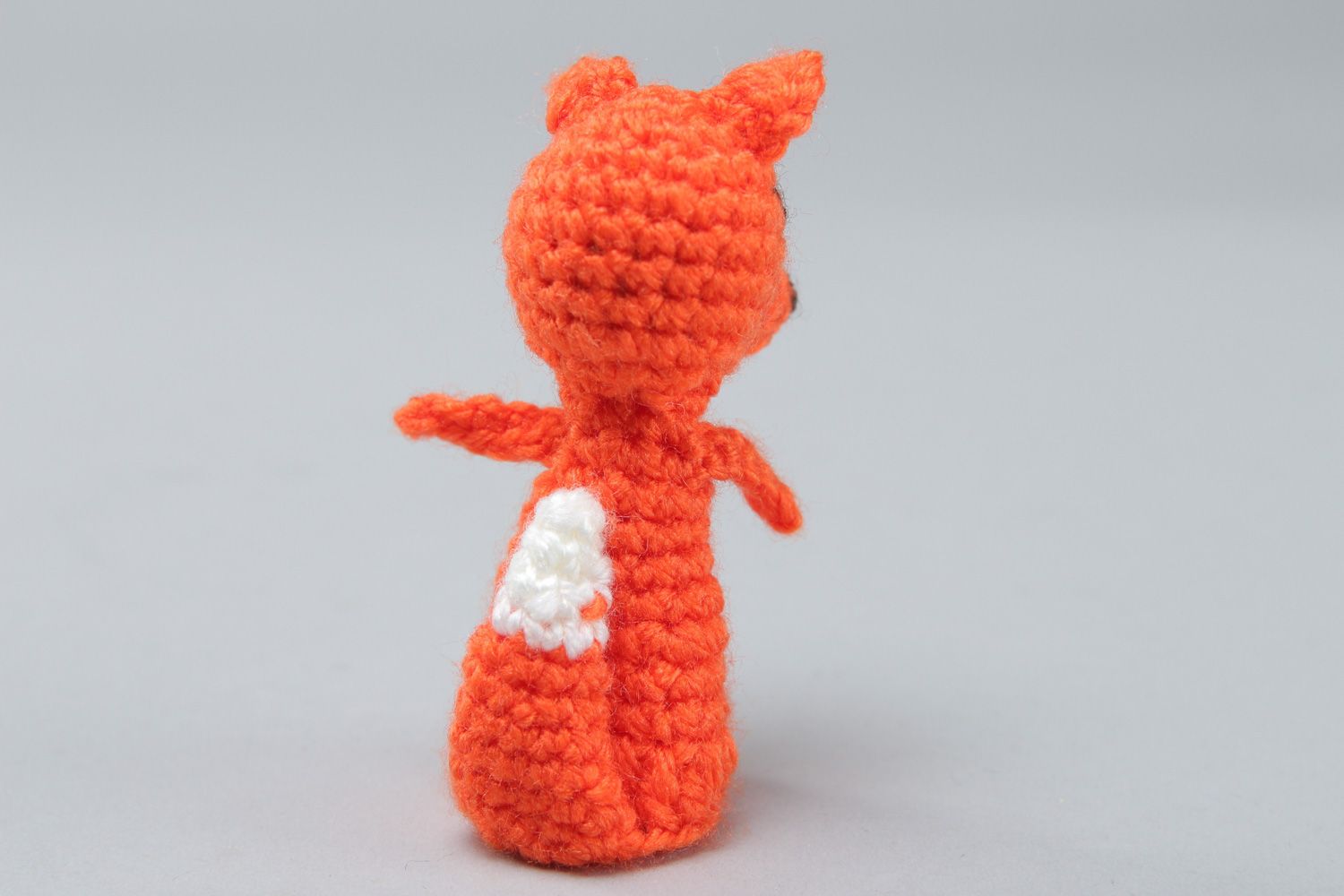 Small handmade finger puppet crocheted of acrylic threads in the shape of red fox photo 2