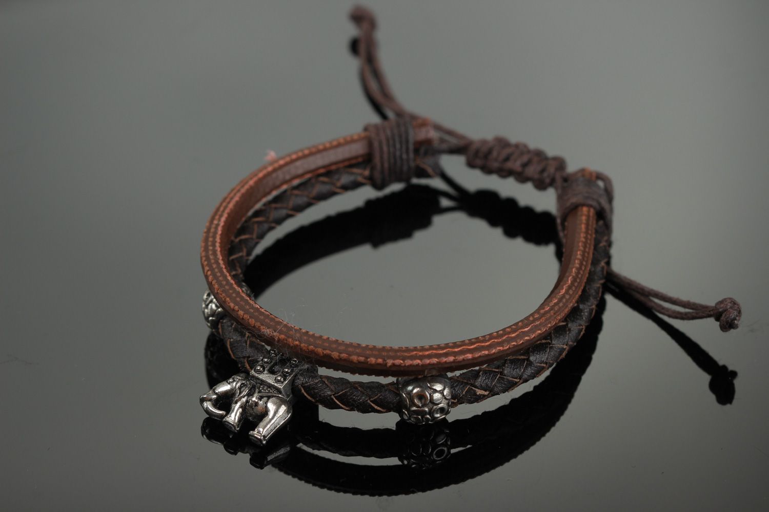 Handmade women's wrist bracelet woven of genuine leather of brown color photo 1