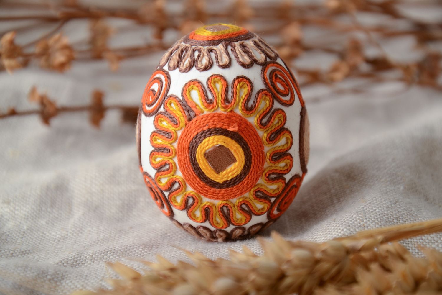 Unusual decorative Easter egg ornamented with threads photo 1