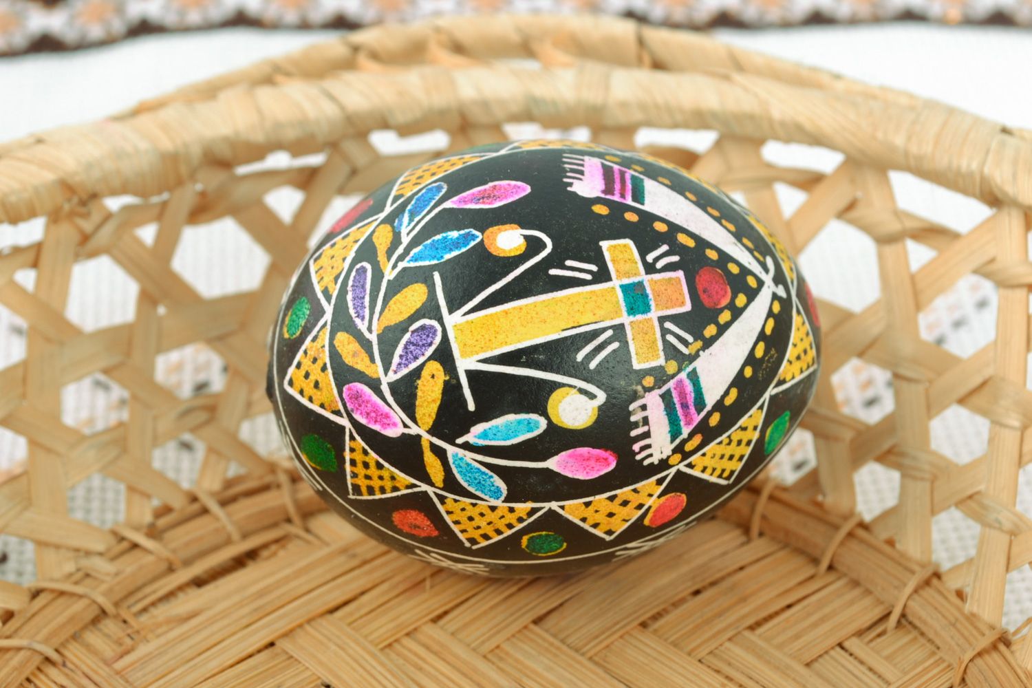 Beautiful chicken Easter egg pysanka with handmade painting on black background photo 1