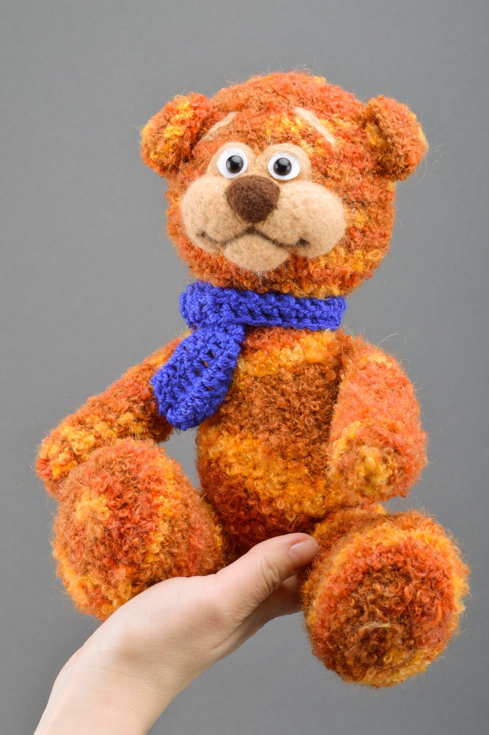 Handmade crochet soft toy in the shape of brown bear with blue scarf for children photo 3