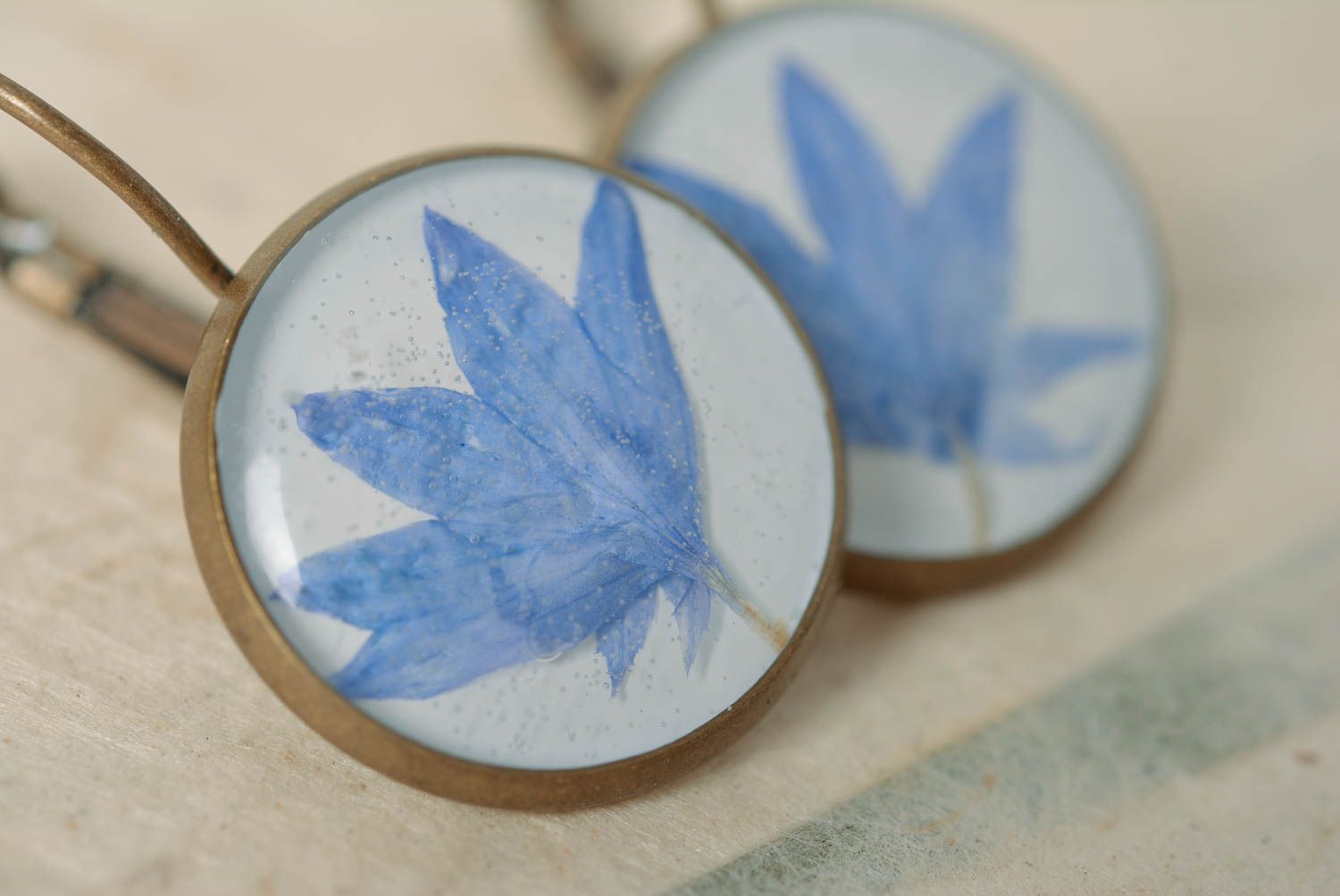Beautiful homemade earrings with dried flowers coated with epoxy photo 3