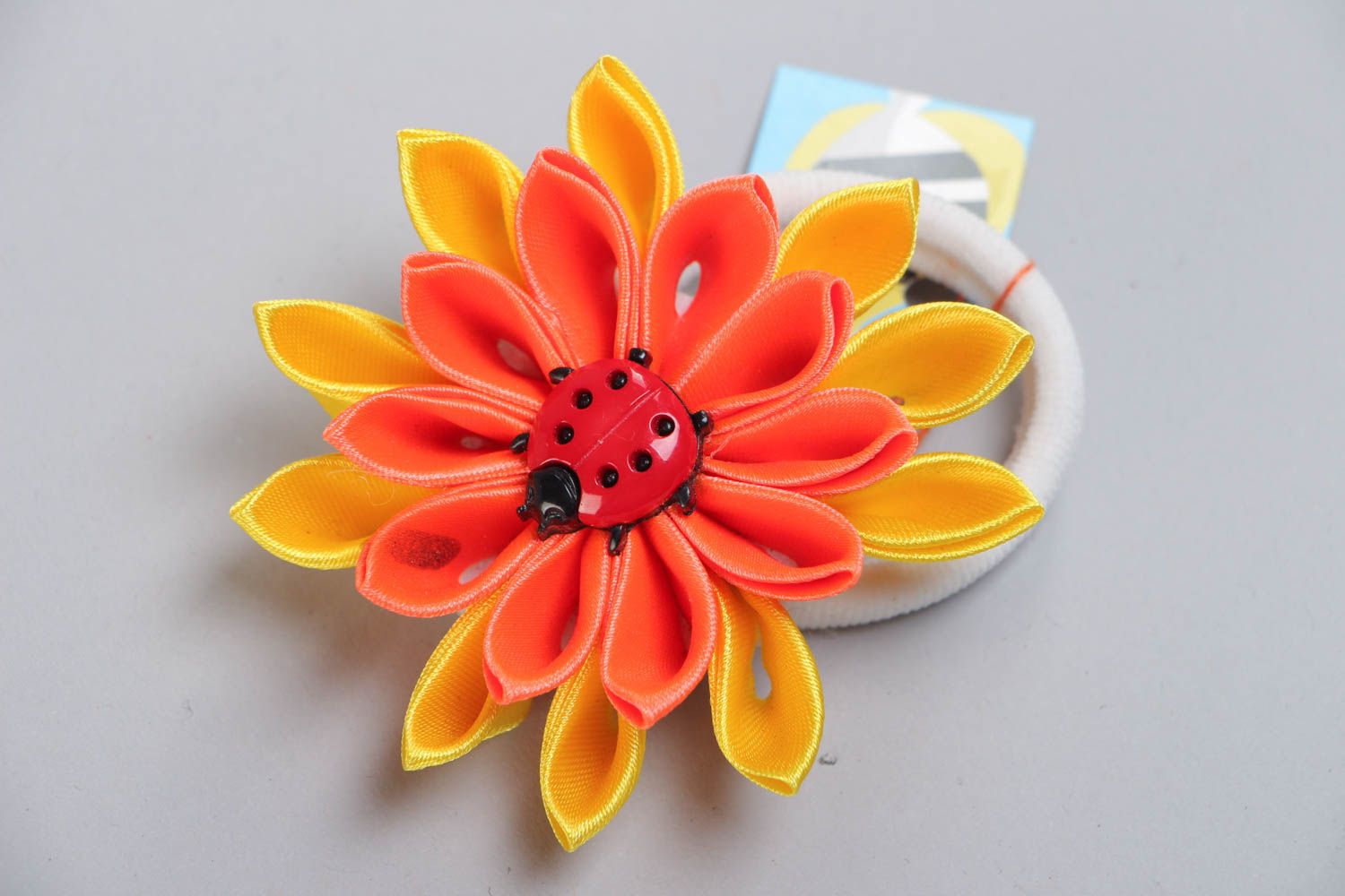 Handmade scrunchy with bright yellow and orange large flower made using kanzashi technique photo 2