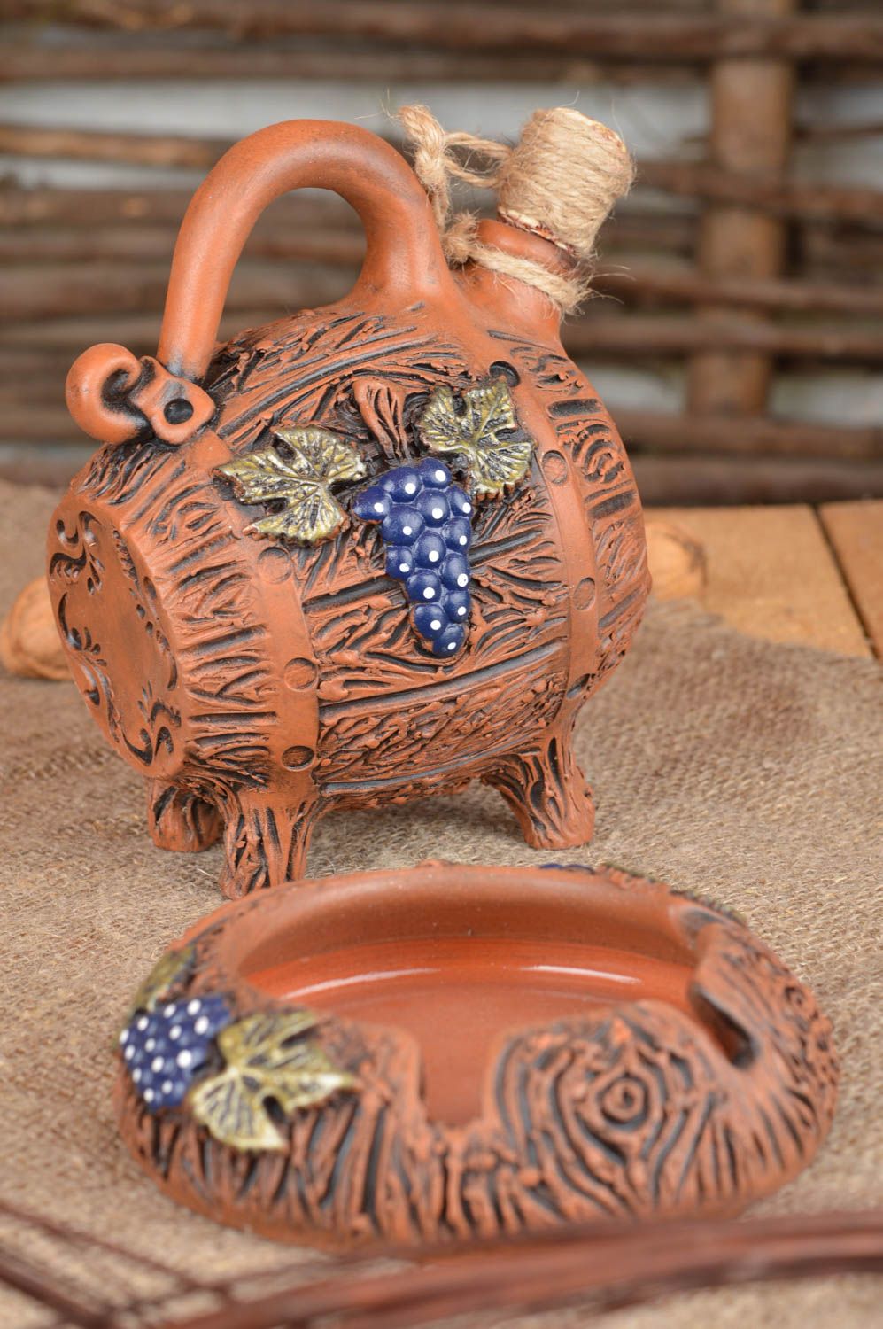 Set of unique handmade ceramic products wine barrel and ashtray made of red clay photo 1