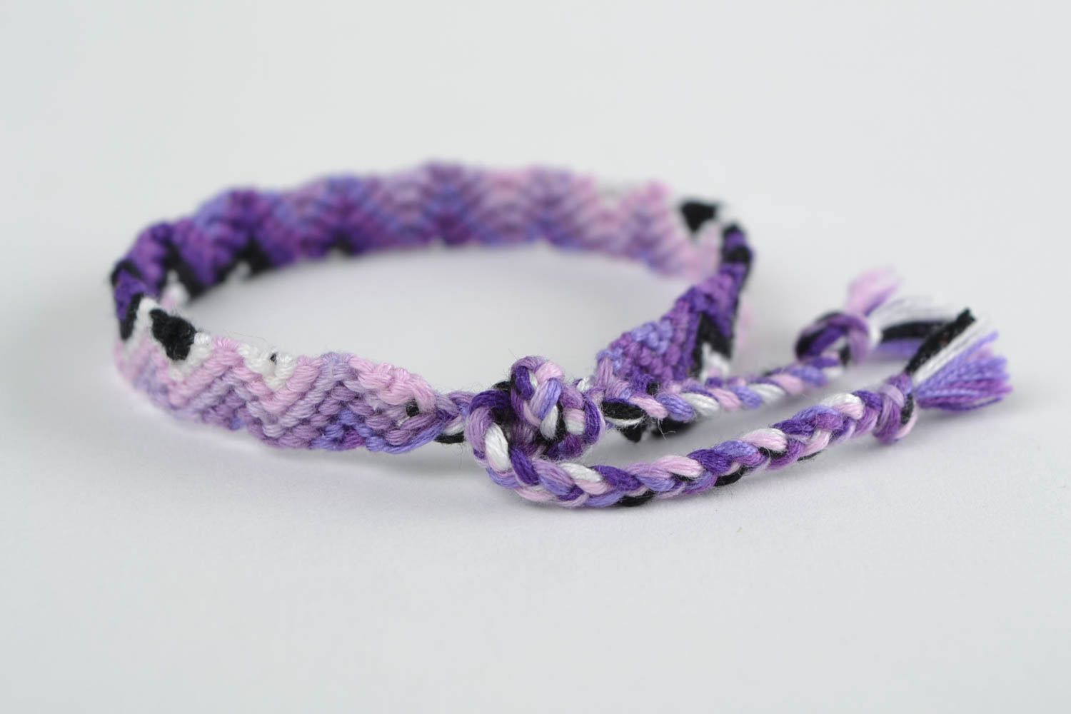 Handmade thin friendship wrist bracelet woven of threads in violet color shades photo 4