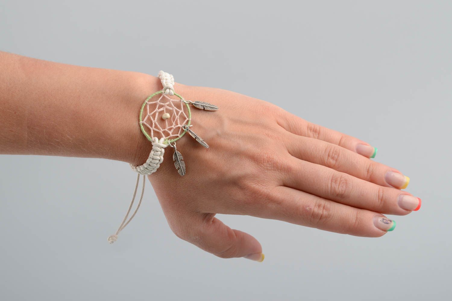 Handmade light macrame woven cord wrist bracelet with dreamcatcher and charms photo 1