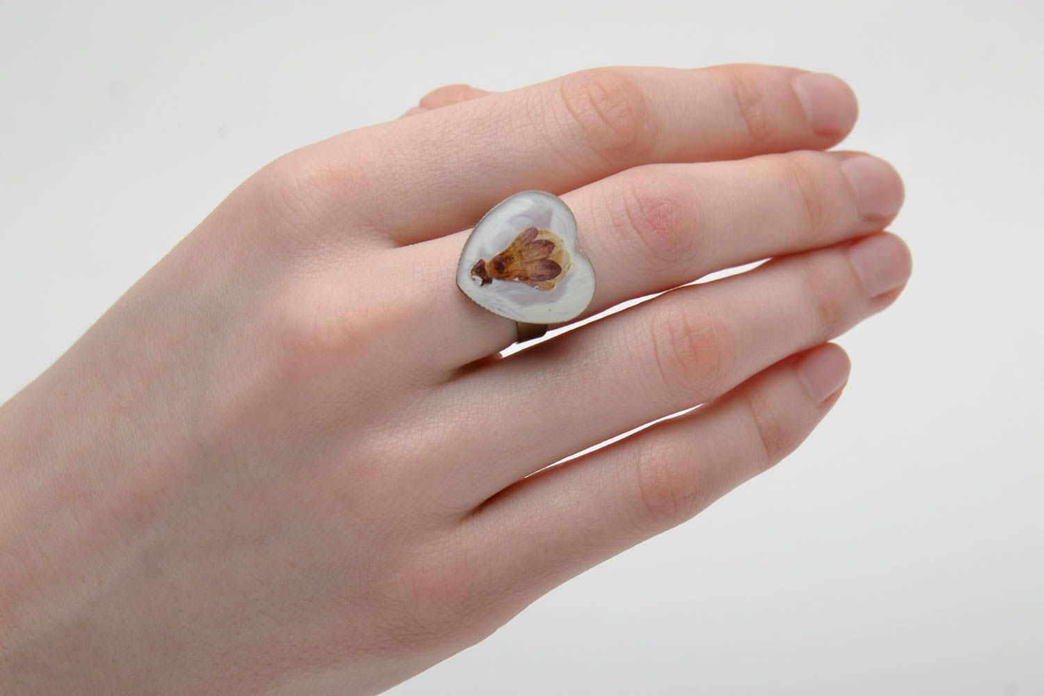 White ring with natural flower in epoxy resin photo 2