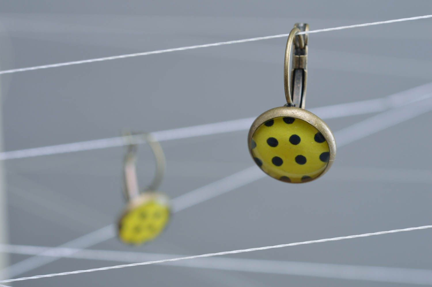 Handmade designer decoupage epoxy earrings of yellow color with black dots photo 1