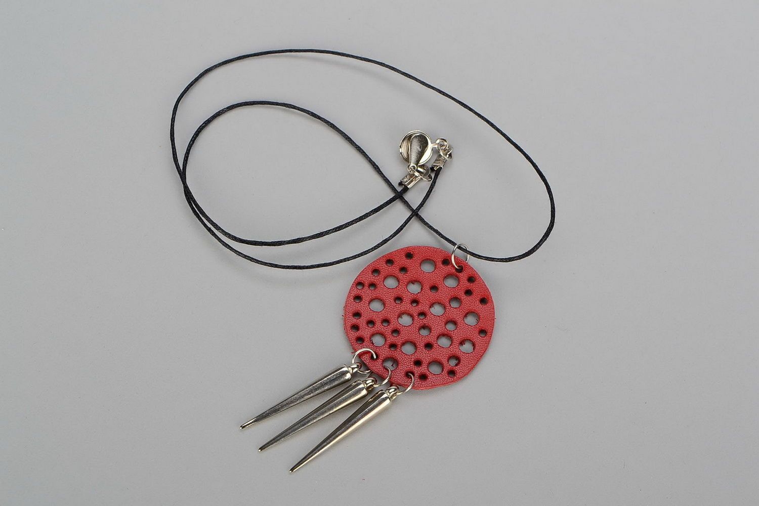 Pendant made of natural leather with studs photo 1