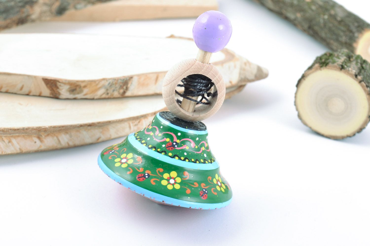 Handmade educational wooden eco toy spinning top painted in green color palette photo 1