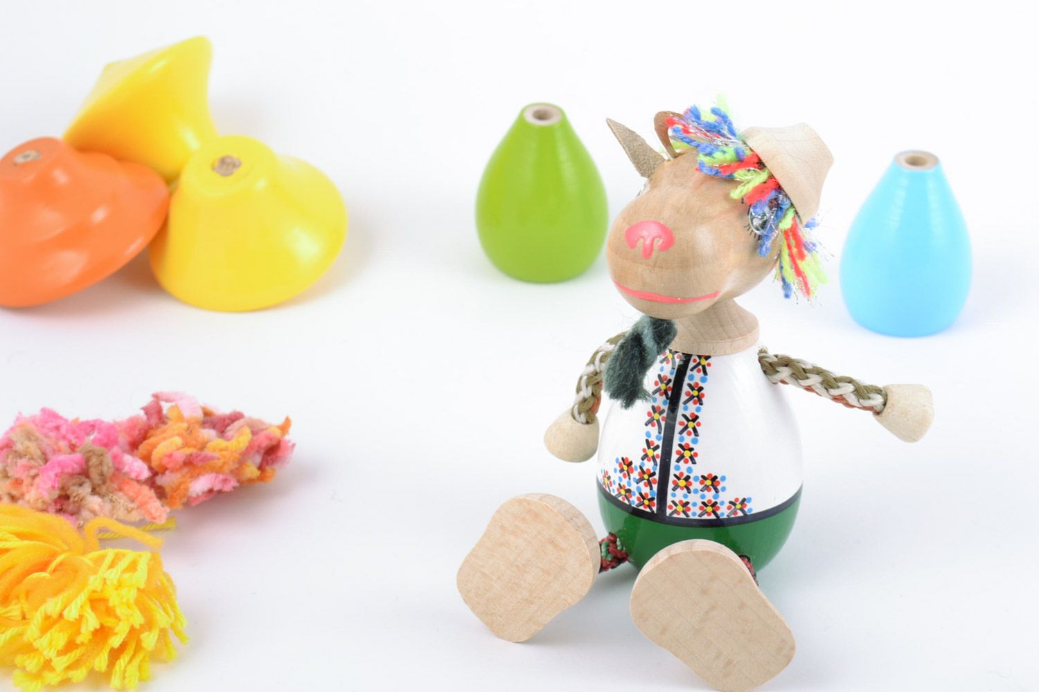 Handmade painted wooden eco toy in the shape of small goat in costume and hat photo 1