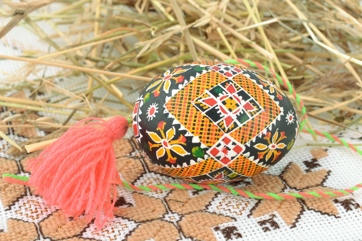 Handmade hanging Easter egg painted with hot wax and decorated with tassel  photo 1
