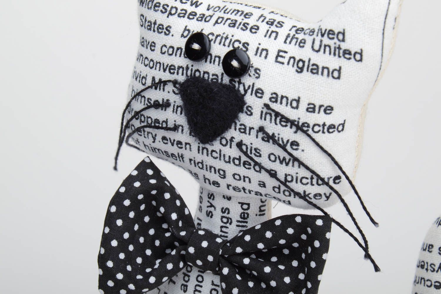 Handmade soft toy sewn of cotton with newspaper pattern Cat with black bow tie photo 3