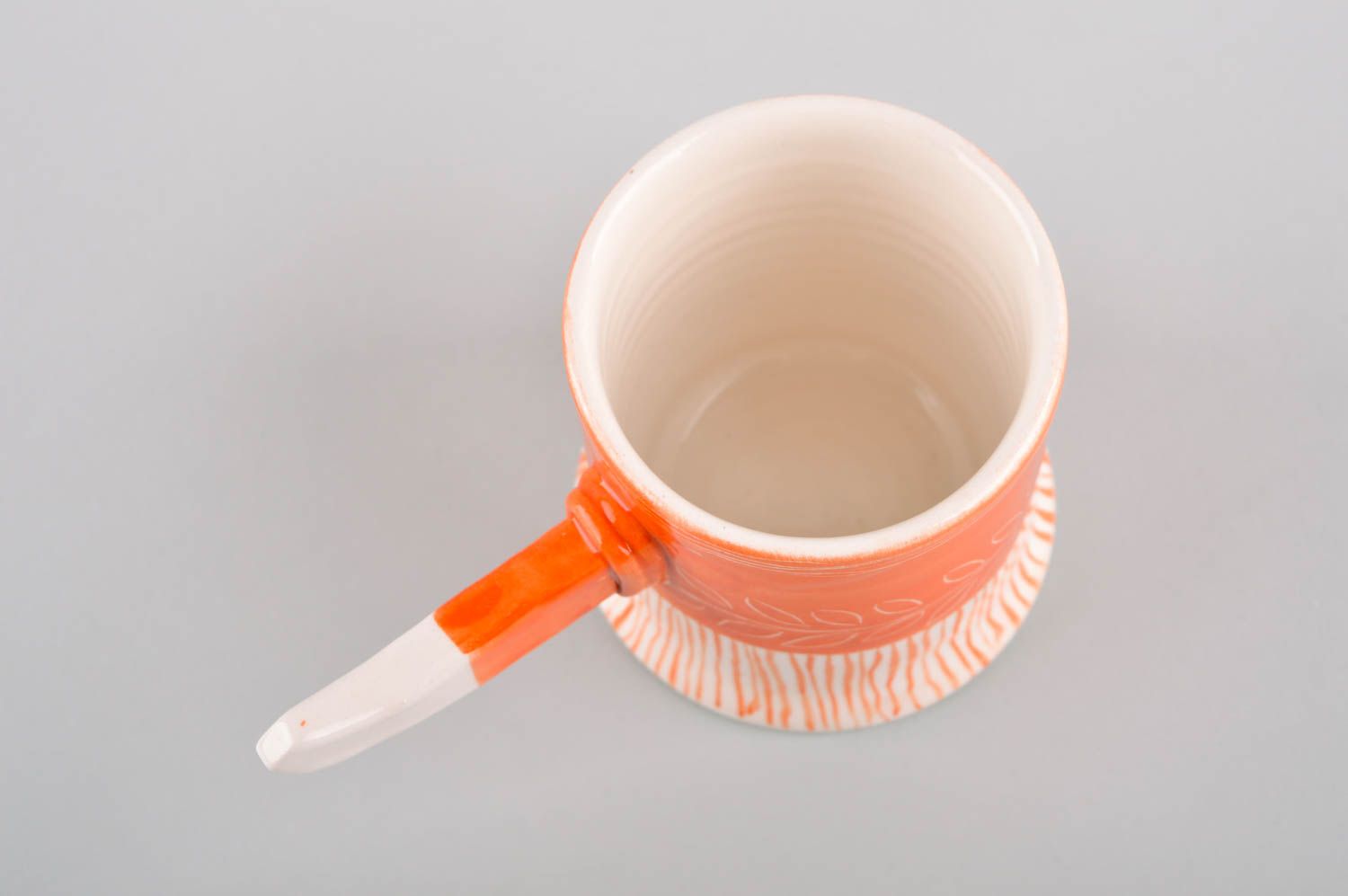 Art style porcelain drinking cup in orange and white color. Stick shape handle. photo 3
