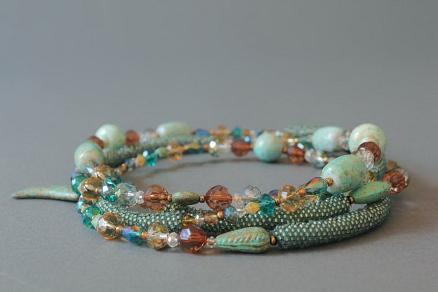 Plaited necklace made from beads with decorative stones photo 1