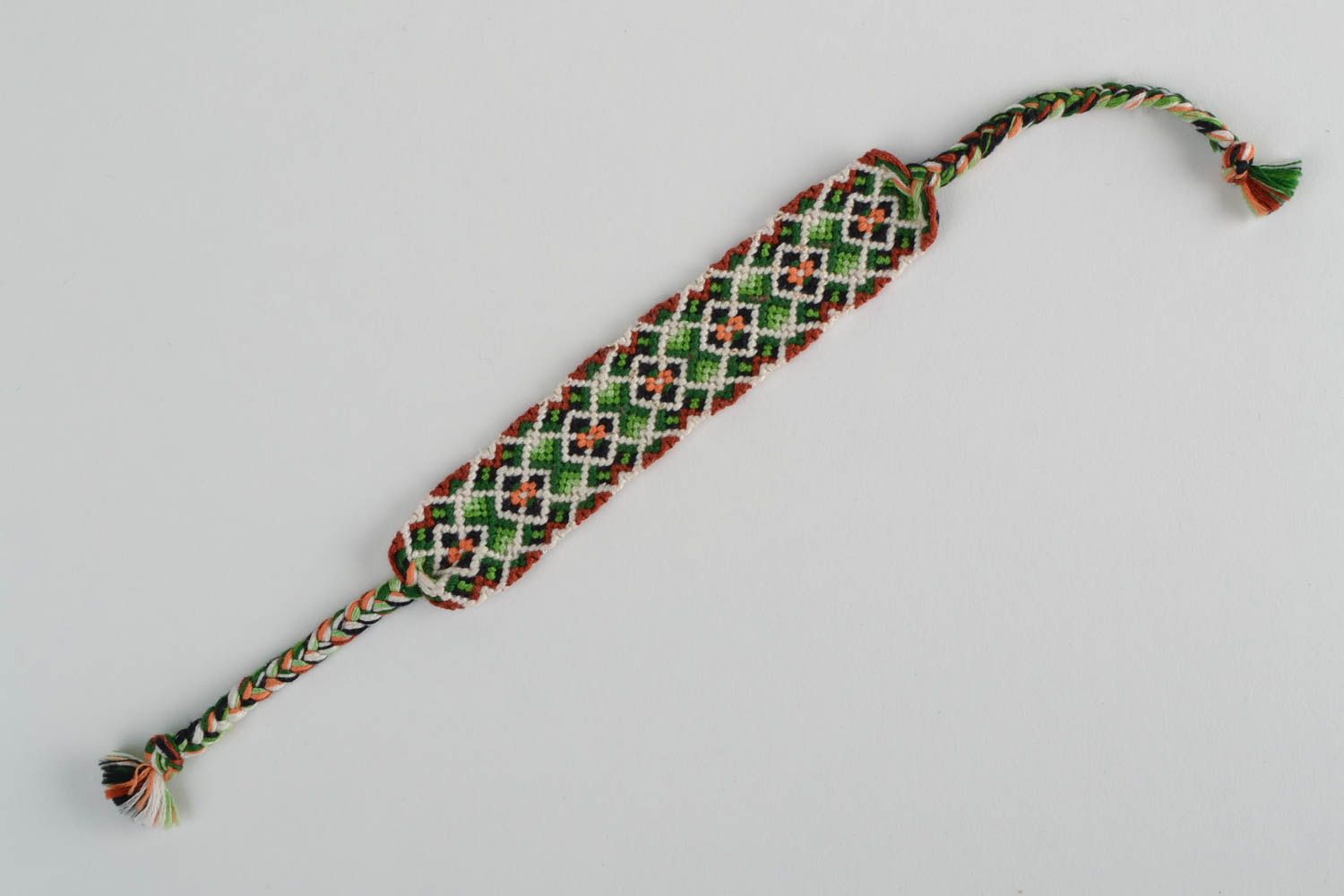 Handmade designer friendship bracelet with green and white geometric ornament  photo 5